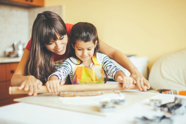 mom and daughter baking at home at Gold Mountain Village Apartments in Central City, Colorado