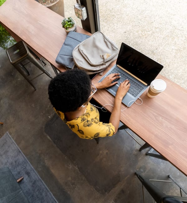 A woman using her laptop in a cafe near Lullwater at Blair Stone in Tallahassee, Florida