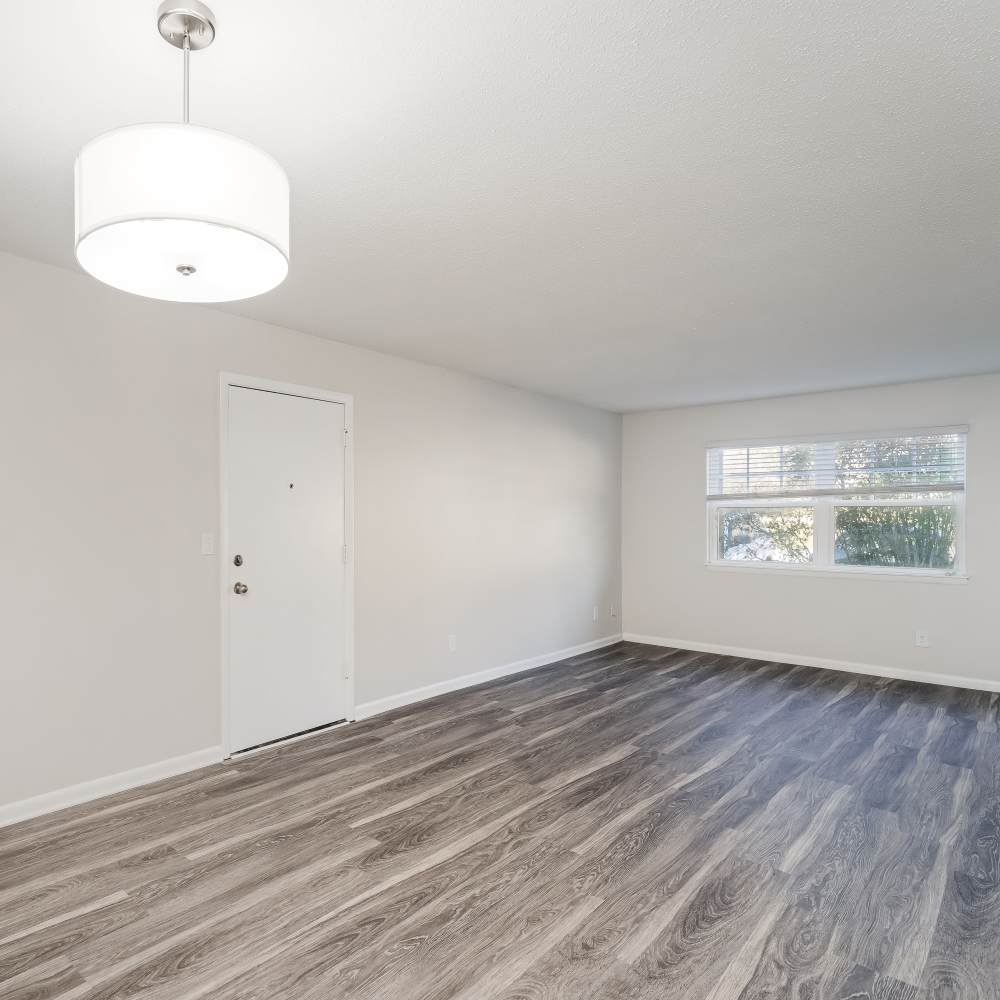 Living room with wood-style flooring at The Links in Chattanooga, Tennessee
