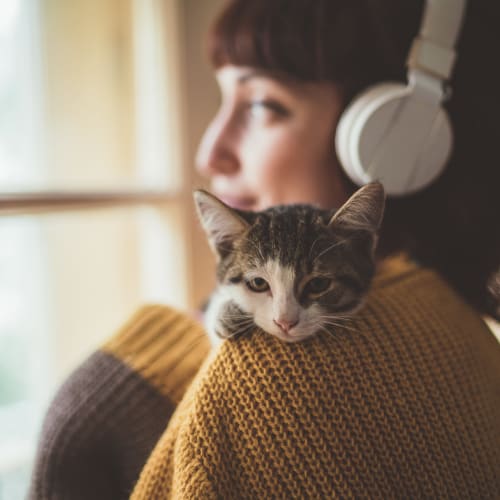 A resident holding a kitten in a home at Eagleview in Joint Base Lewis McChord, Washington