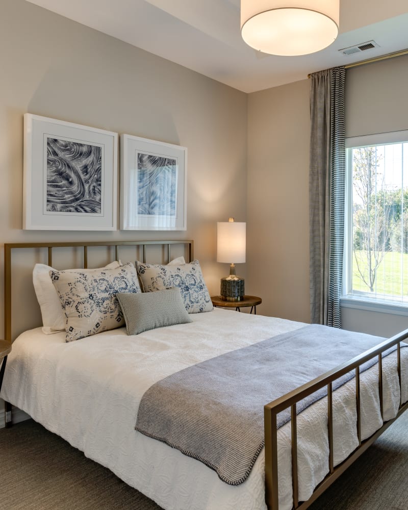 Model bedroom with ample natural light at Encore at Deerhill in Clarkston, Michigan