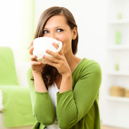 Resident drinking from a mug at Bayview Hills in San Diego, California