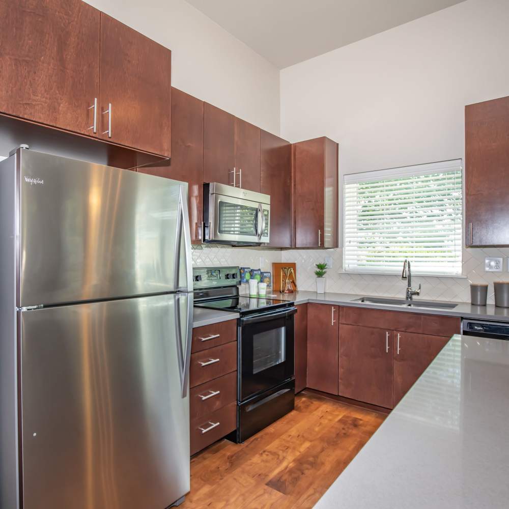 Modern kitchen with stainless-steel appliances at Park Place Olde Town Apartments in Arvada, Colorado