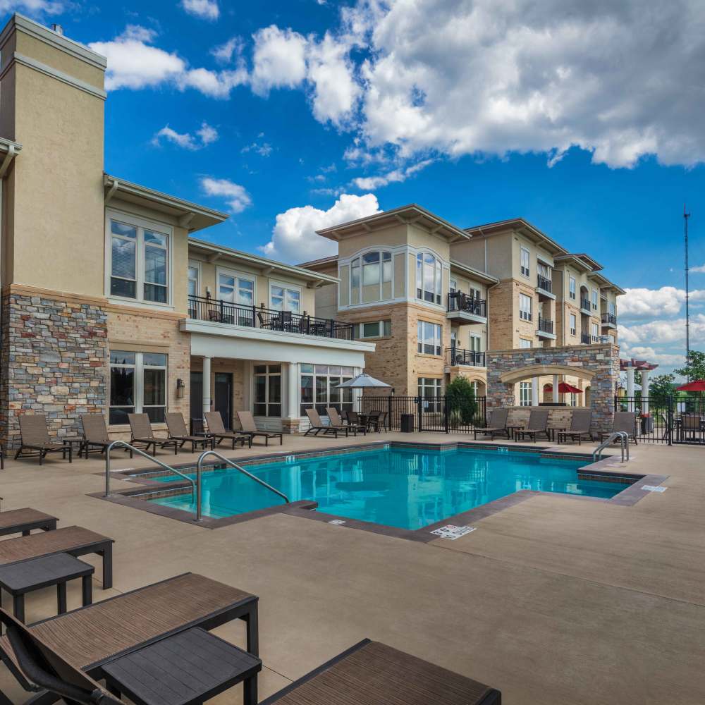 Swimming pool with lounge beds at The Tuscany On Pleasant View in Madison, Wisconsin