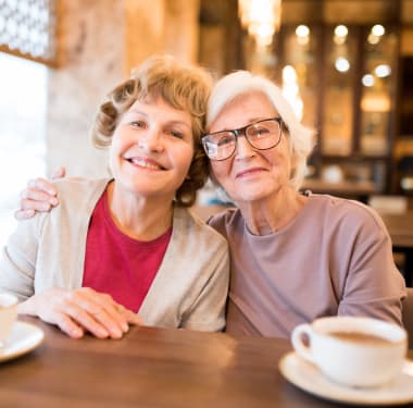 Two resident friends getting coffee at Mirror Lake Village Senior Living Community in Federal Way, Washington.