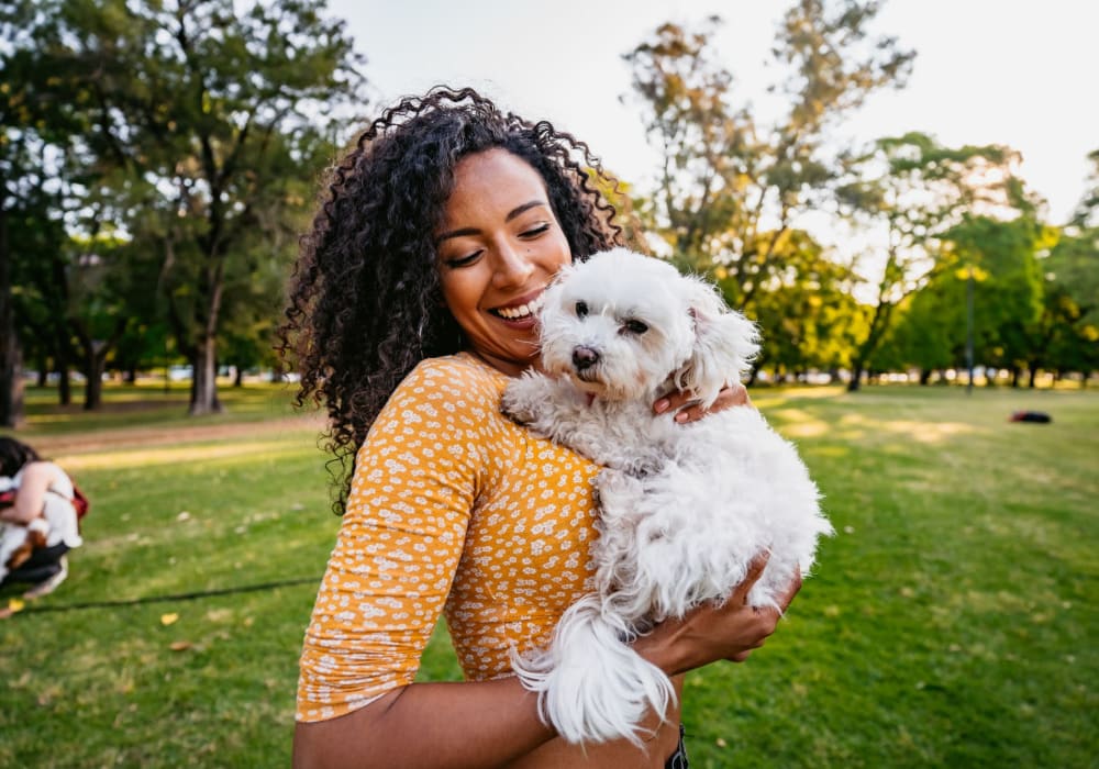 Resident with her puppy at The Ralston at Belmont Hills in Belmont, California