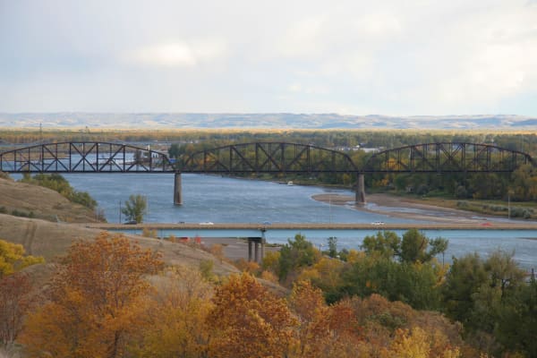 Cars going over a bridge with a river underneath near Touchmark on West Century in Bismarck, North Dakota hiking