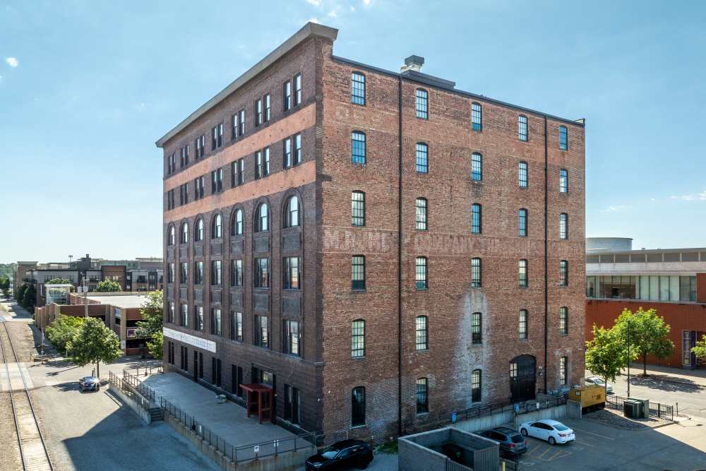 Building with multiple windows and brick exterior at Rumely Lofts in Des Moines, Iowa