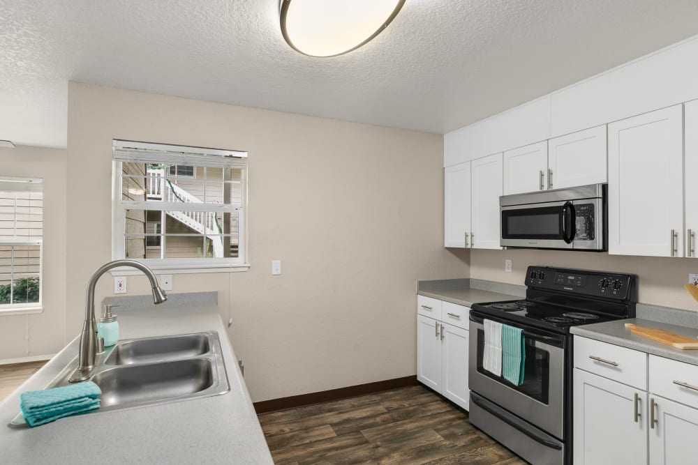 White cabinetry in a renovated kitchen at Carriage Park Apartments in Vancouver, Washington