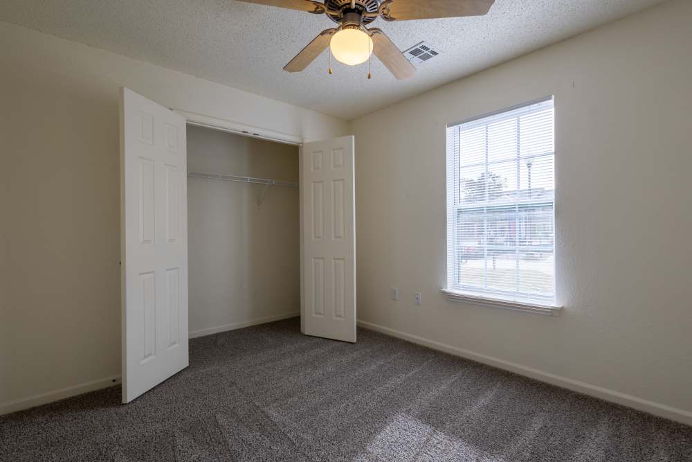 Charming bedroom with carpeted flooring and natural light at Adobe Ranch in Borger, Texas.
