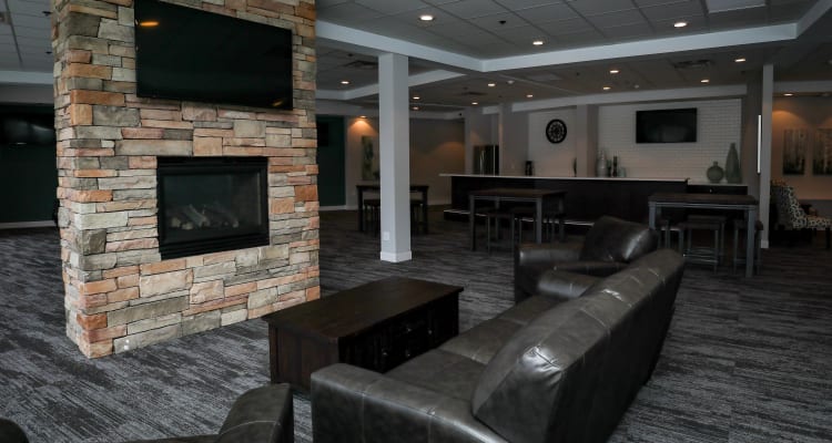 Clubroom lounge with a fireplace at Creekview Court in Getzville, New York