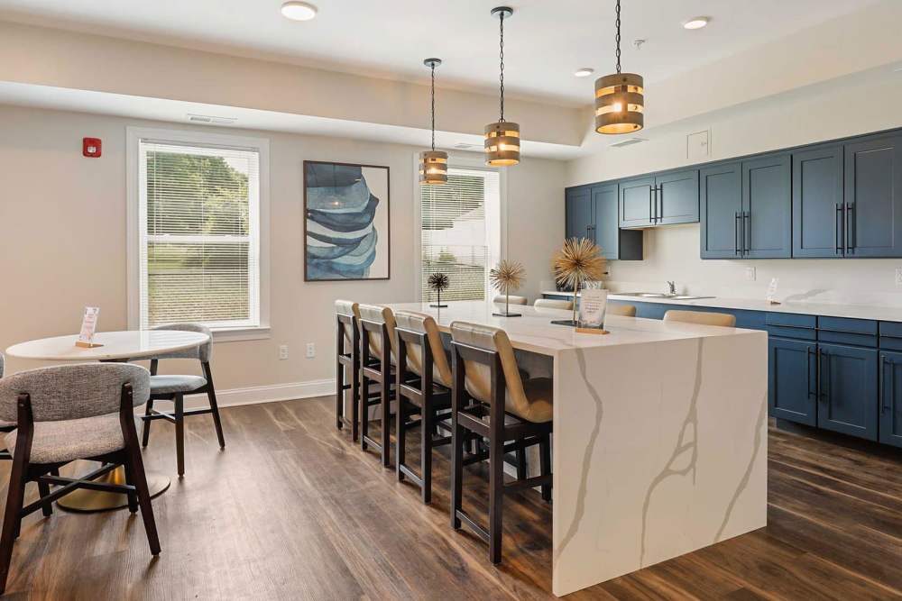 Open-concept apartment kitchen and dining area with modern finishes at Taneytown Crossing in Taneytown, Maryland