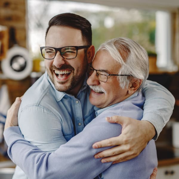 An elderly father embracing his son near Key Storage in San Antonio, Texas,