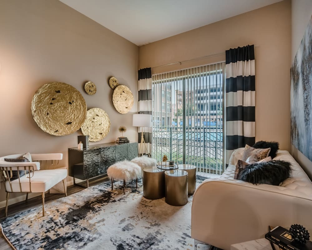 Large open-concept living area in a model apartment home at Olympus Boulevard in Frisco, Texas