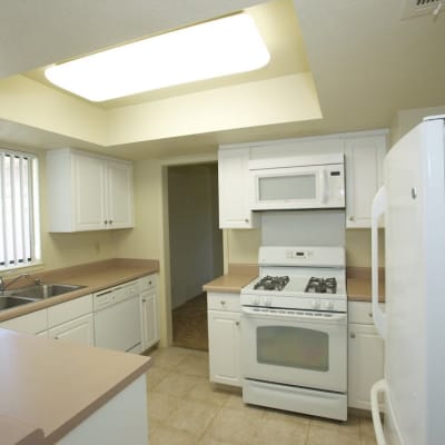 A kitchen with appliances in a home at South Mesa II in Oceanside, California