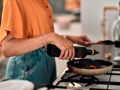 Woman cooking at Palace Apartments in Concord, California