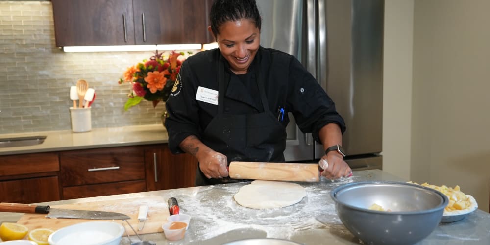Baker rolling out dough at The Springs at Happy Valley in Happy Valley, Oregon