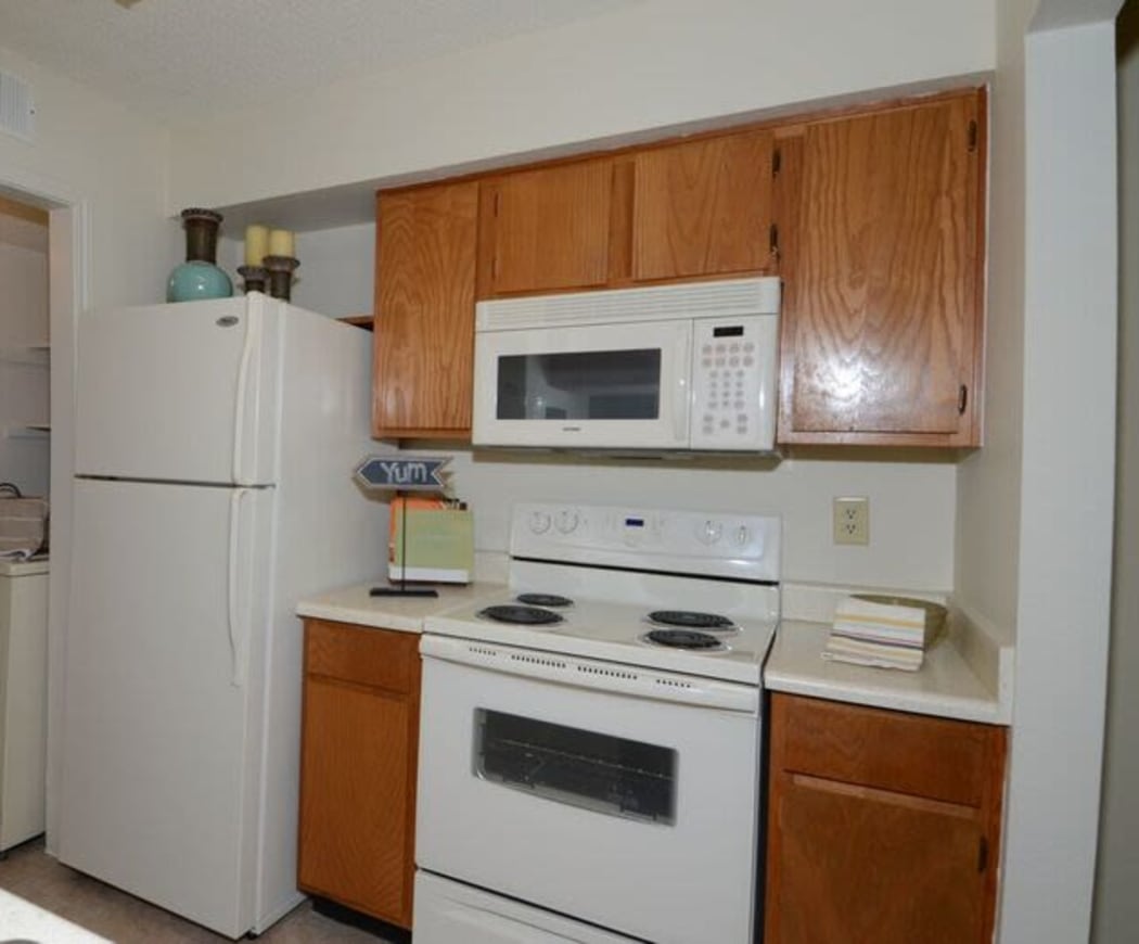 Kitchen with white appliances at Newport Apartments in Amarillo, Texas