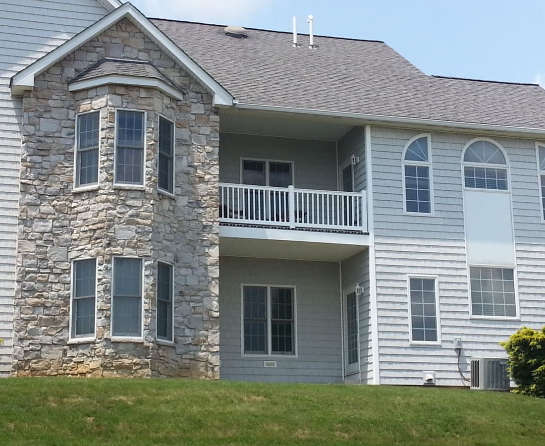 Exterior with private patio and balcony at Springhouse Townhomes in Allentown, Pennsylvania