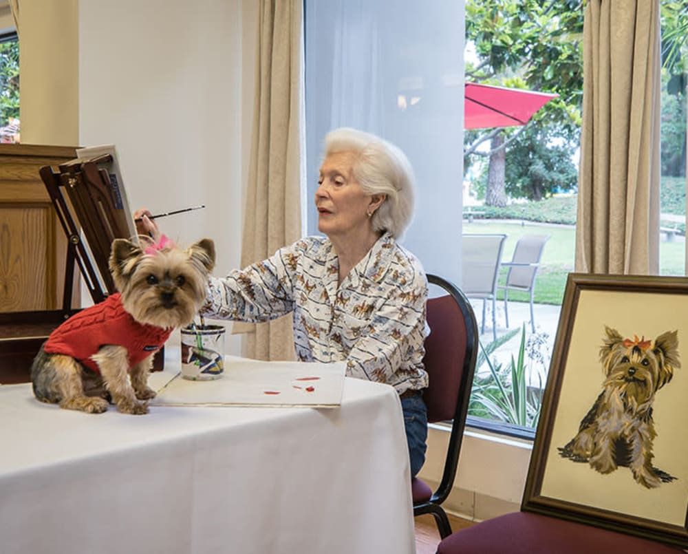 Resident painting with her dog at Pasadena Highlands in Pasadena, California
