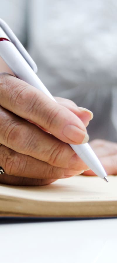 Resident signing papers at a WISH community