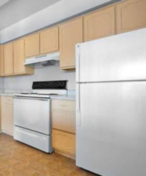 Stainless steel oven and fridge in a kitchen at Towne Crest in Gaithersburg, Maryland