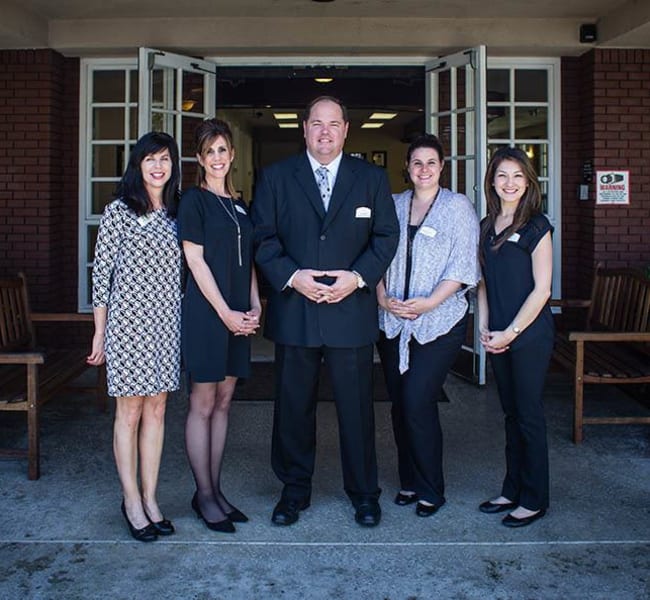 Some of the team posing for a photo at the entrance to Carmel Village in Fountain Valley, California