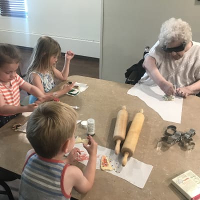 A resident and children making cookies at Ebenezer Ridges Campus in Burnsville, Minnesota