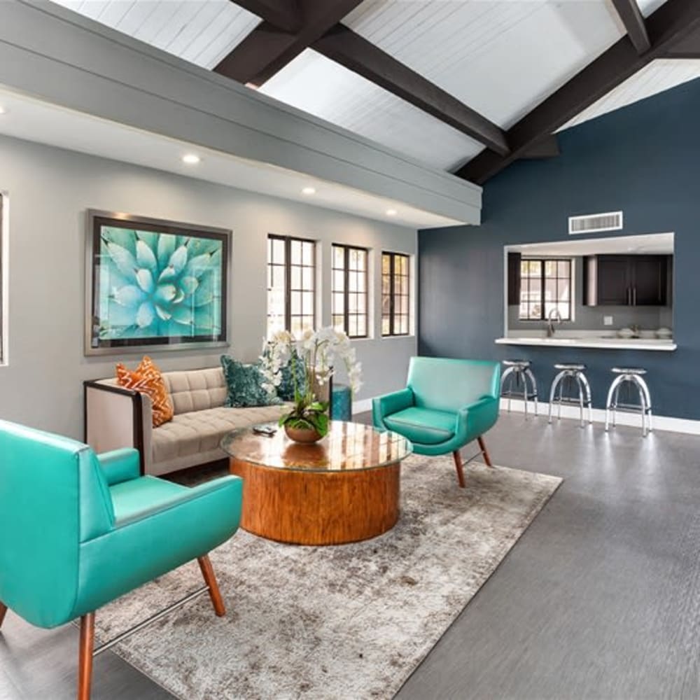 A clubhouse with comfortable seating and a community kitchen at Argenta Apartments in Mesa, Arizona