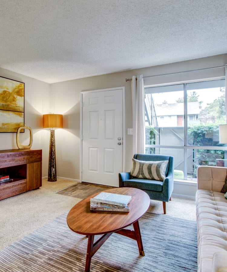 Retro-modern decor and draped windows in a model home's living area at Vue Fremont in Fremont, California