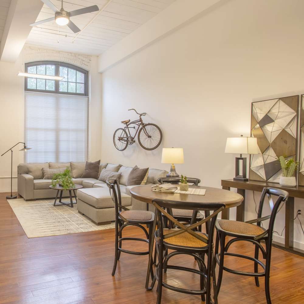 Dining space and seating area of the living room of an apartment at Lofts at Inman Mills in Inman, South Carolina