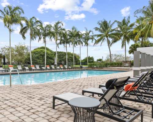 Pool patio with lounge chairs at Atwater Apartment Homes, Sunrise, Florida