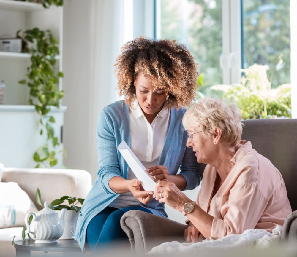 Woman reading with caregiver at Clearwater at Rancharrah in Reno, Nevada. 