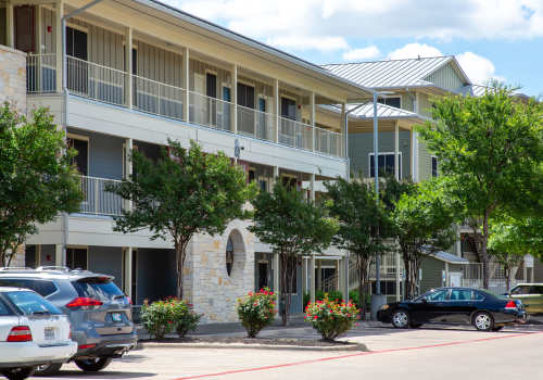 Community exterior with parked cars at M Station in Austin, Texas