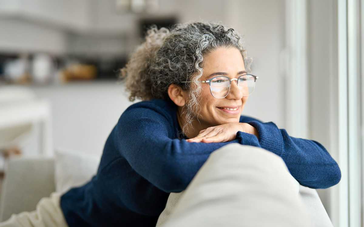 Resident looking out their apartment window at Addison Grove in Avon Park, Florida