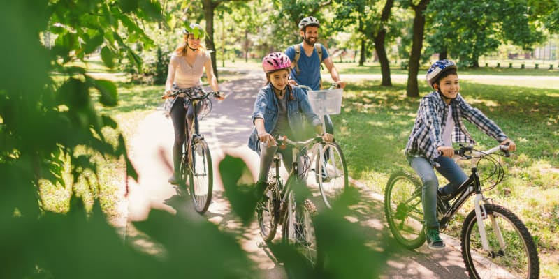 a family riding bikes near Terrace View Villas in San Diego, California