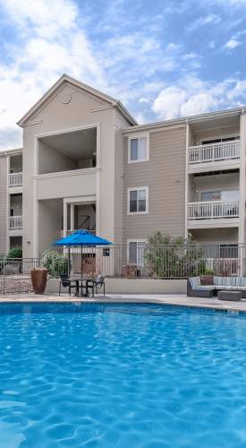 Swimming pool with lounge seating at One Belmar Place in Lakewood,Colorado