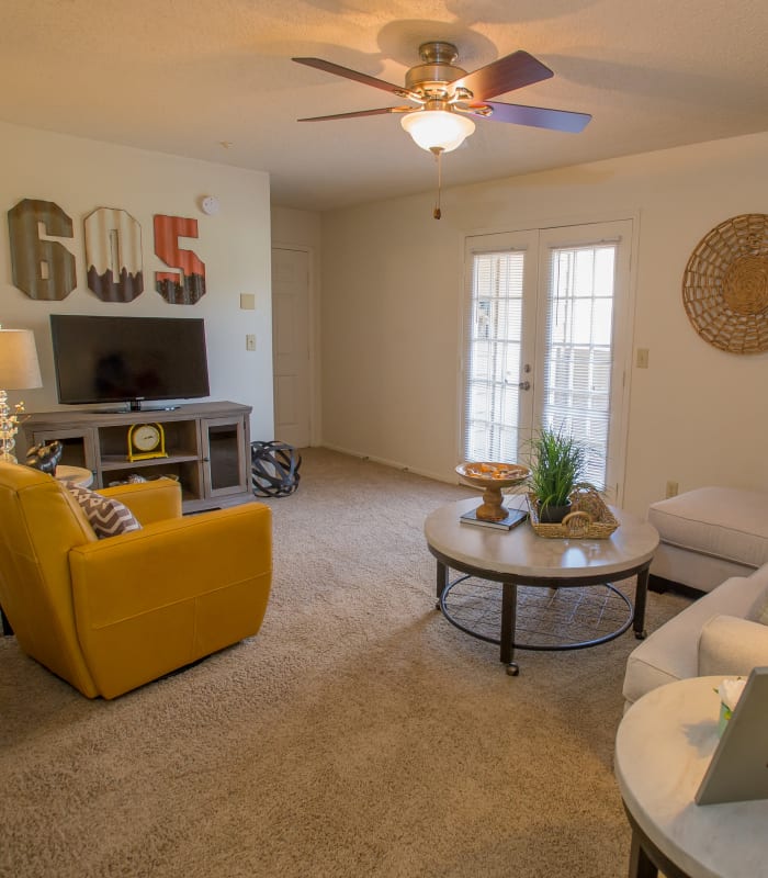 Spacious living room with large windows at Cimarron Trails Apartments in Norman, Oklahoma