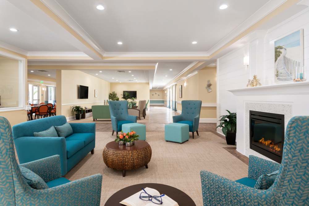 Community seating area with fire place at The Pineapple House at Sapphire Lakes in Naples, Florida