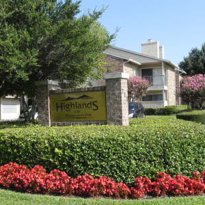 Signage and flowers at the main entrance to Highlands of Duncanville in Duncanville, Texas