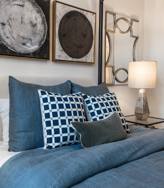 Bedroom with side lamp at The Everly at Rouzan in Baton Rouge, Louisiana
