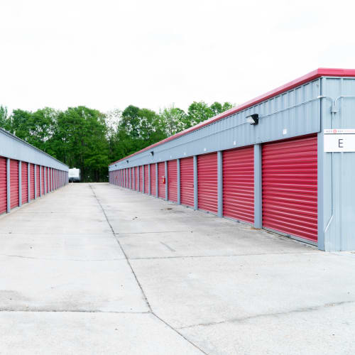 Row of outdoor storage units with red doors at Red Dot Storage in Denham Springs, Louisiana