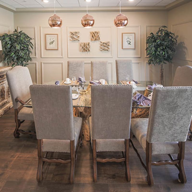 Resident dining room with upholstered chairs at The Views at Lake Havasu in Lake Havasu City, Arizona