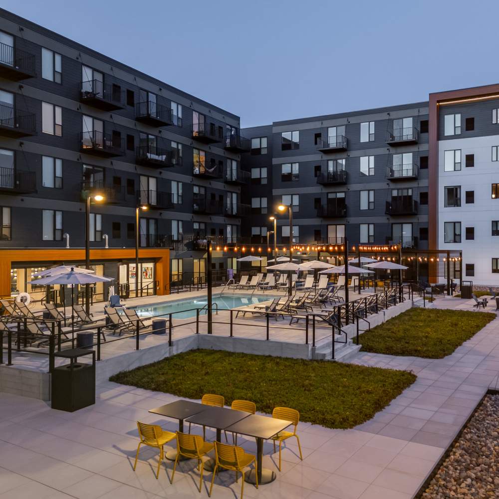 Twilight view of community with cabana and swimming pool at Oaks Pentagon Village in Edina, Minnesota