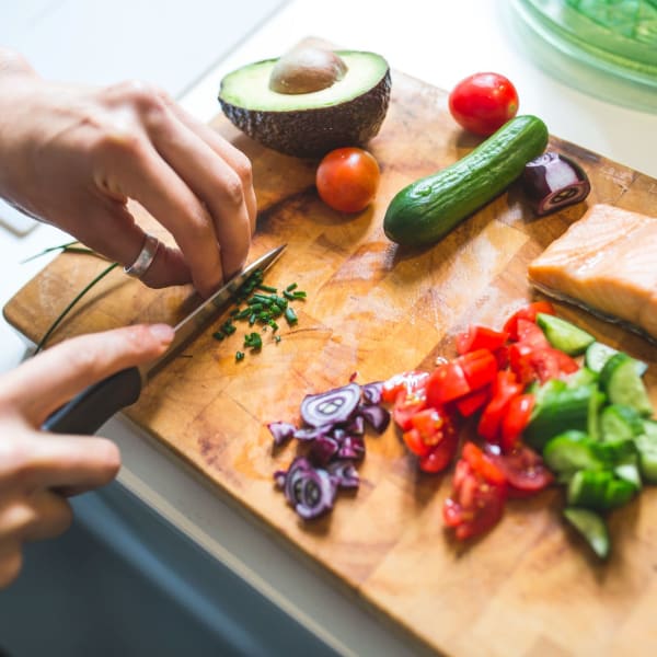 Resident making dinner at The Courtyard Apartment Homes in Mukilteo, Washington