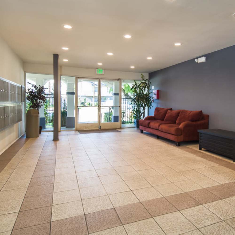 Clubhouse lobby area with sofa and mailbox at Tarzana Courtyard in Tarzana, California,