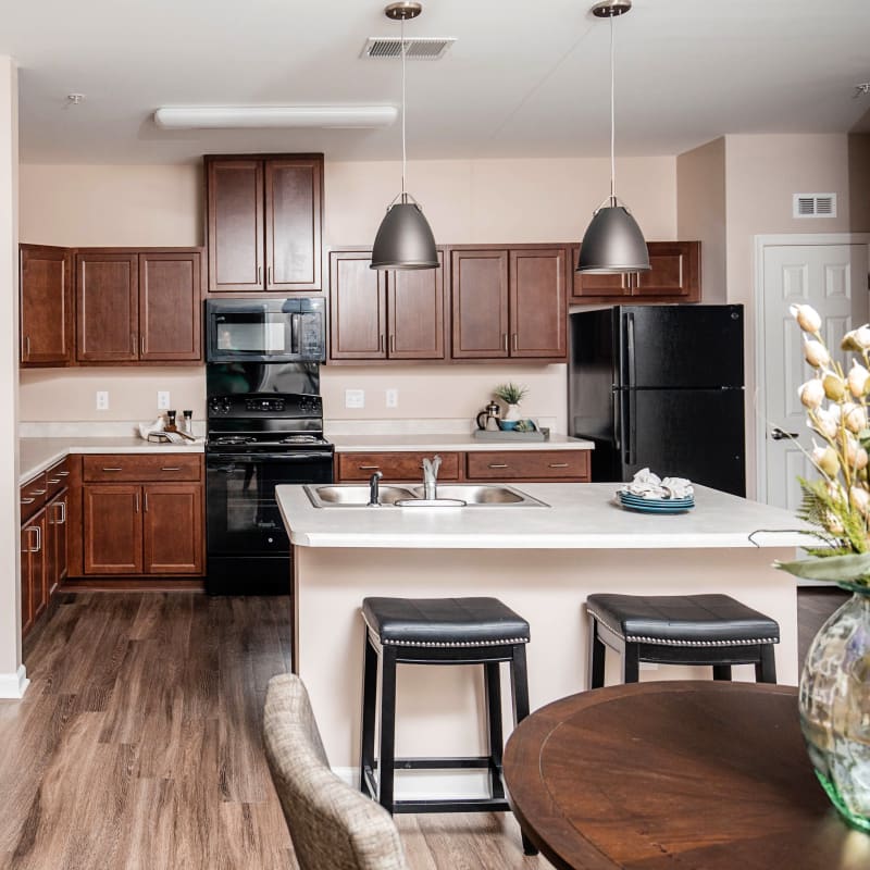 Model kitchen with island and counter seating at The Joyce in Durham, North Carolina