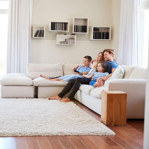 A resident family enjoying time together on the couch at Port Lyautey in Virginia Beach, Virginia