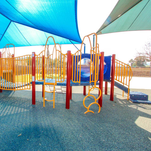 Playground equipment under a shade cover at Woodlake in Lakeside, California