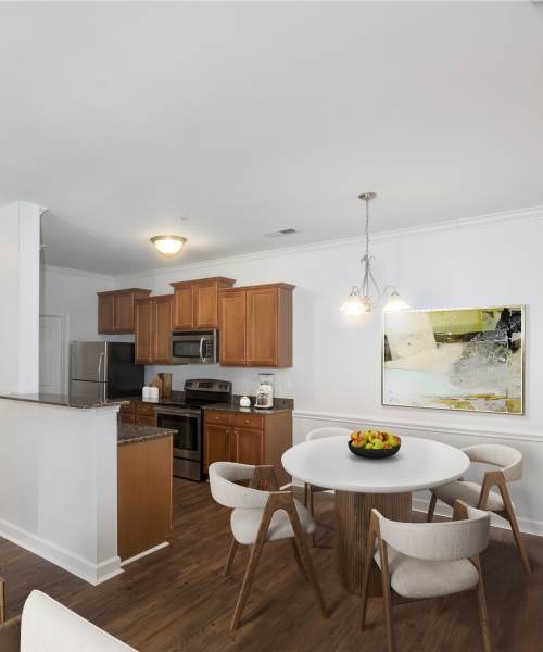 Modern kitchen with dining area at Crystal Lake & Kingsley Apartments and Townhomes in Fayetteville, North Carolina